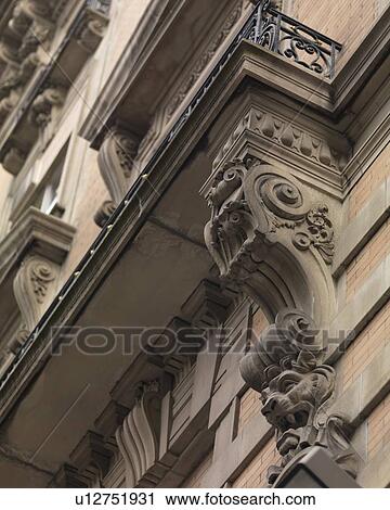 Stock Image - Decorative carvings on exterior of a building in Manhattan, New York City, U. S. A.. Fotosearch
