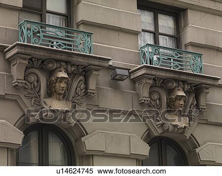 Stock Photography - Decorative carvings on exterior of a building in Manhattan, New York City, U. S. A.. Fotosearch