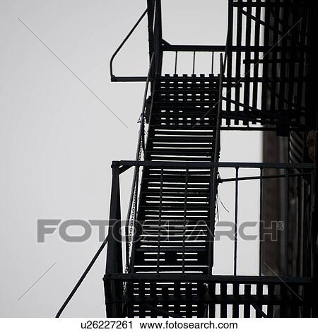 Stock Image - Exterior fire escape on a building in Manhattan, New York City, U. S. A.. Fotosearch