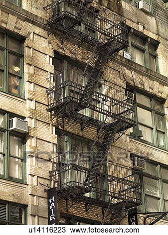 Stock Image - Fire escape on the exterior of a building in New York City. Fotosearch