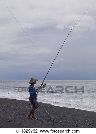 Stock Image - Fisherman on shore in Bali. Fotosearch