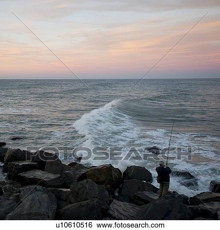Stock Photograph - Fisherman on the Hamptons seashore. Fotosearch