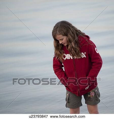 Stock Photo - Girl along shoreline in Gimli, Manitoba, Canada. Fotosearch