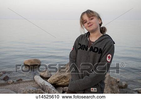 Stock Image - Girl along the shoreline in Gimli, Manitoba, Canada. Fotosearch