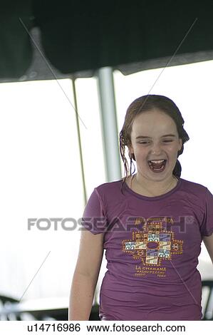 Stock Photograph - Girl laughing in Gimli, Manitoba, Canada. Fotosearch
