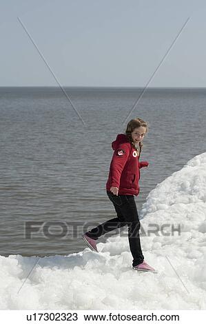 Girl standing on a pile of snow at Winnipeg Beach, Manitoba, Canada View Large Photo Image Stock Image - Girl standing on a pile of snow at Winnipeg Beach, Manitoba, Canada. Fotosearch