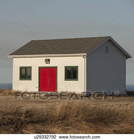 Stock Image - House with a red door in Gimli, Manitoba, Canada. Fotosearch