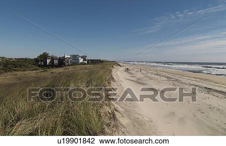 Stock Image - Houses along Bridgehampton Beach, the Hamptons. Fotosearch