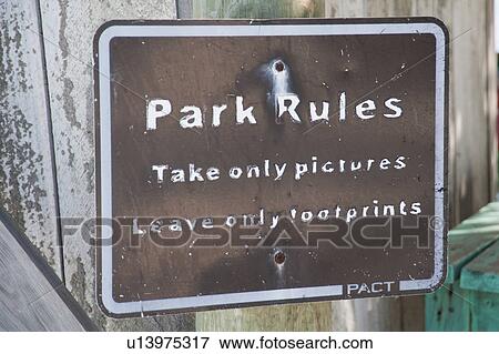 Stock Photo - Laughing Bird Caye, Fence With Sign. Fotosearch