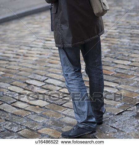 Lower portion of a man standing on a street in Manhattan, New York City, U. S. A. View Large Photo Image Stock Image - Lower portion of a man standing on a street in Manhattan, New York City, U. S. A.. Fotosearch