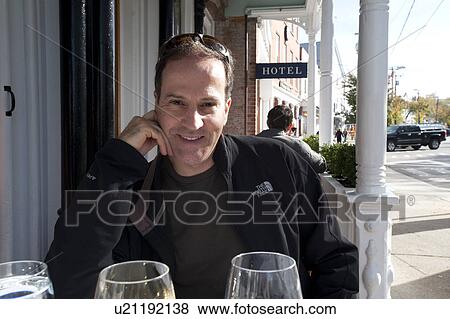 Man at a street cafe in Sag Harbor View Large Photo Image Stock Photo - Man at a street cafe in Sag Harbor. Fotosearch