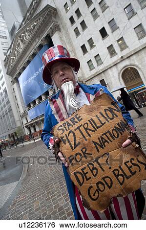 Stock Photograph - Man dressed in costume with a sign in Manhattan, New York City, U. S. A.. Fotosearch