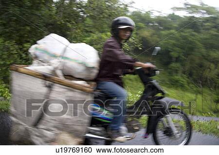 Man on motorbike in Bali View Large Photo Image Stock Image - Man on motorbike in Bali. Fotosearch