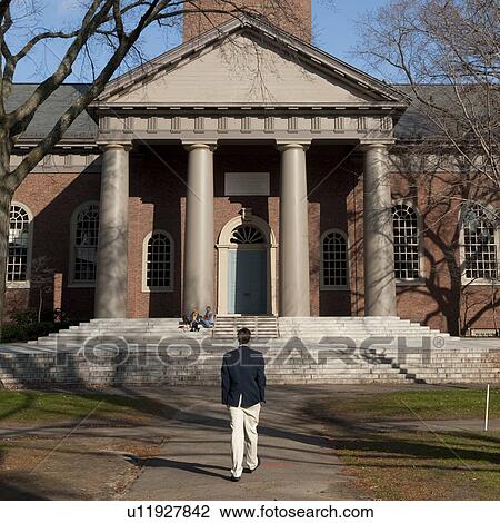 Stock Image - Man walking towards an historic building in Boston, Massachusetts, USA. Fotosearch