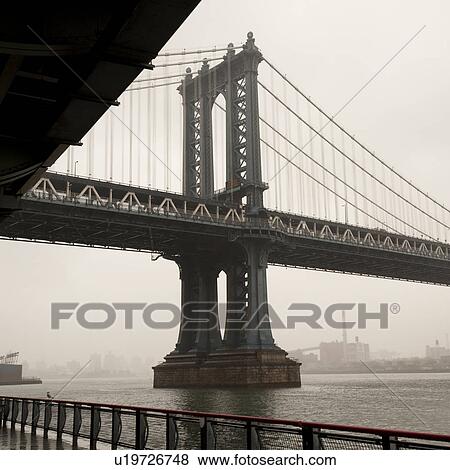 Stock Photo - Manhattan Bridge over East River in Manhattan, New York City, U. S. A.. Fotosearch