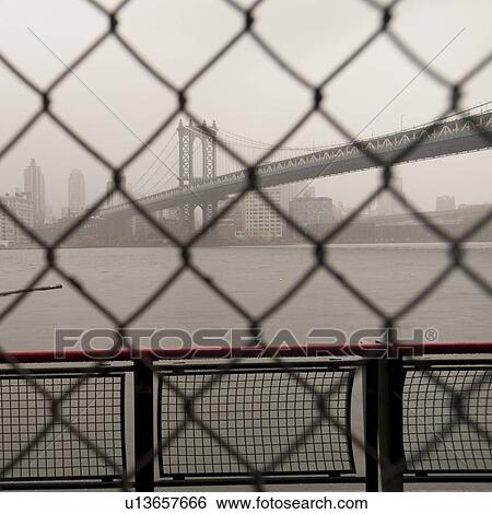 Manhattan Bridge through a chain link fence in Manhattan, New York City, U. S. A. View Large Photo Image Stock Photograph - Manhattan Bridge through a chain link fence in Manhattan, New York City, U. S. A.. Fotosearch