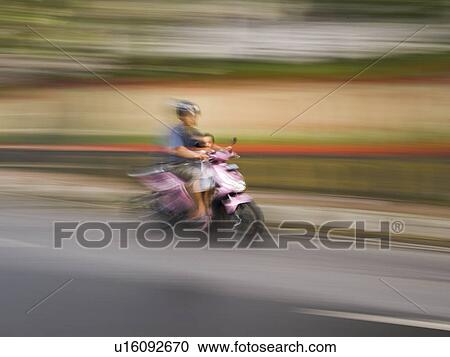Stock Image - Motorbike on roadway in Bali. Fotosearch