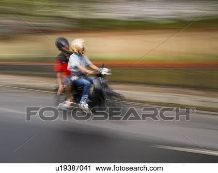 Stock Image - Motorbike on roadway in Bali. Fotosearch