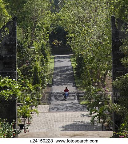 Stock Photo - Motorbike on roadway in Bali. Fotosearch