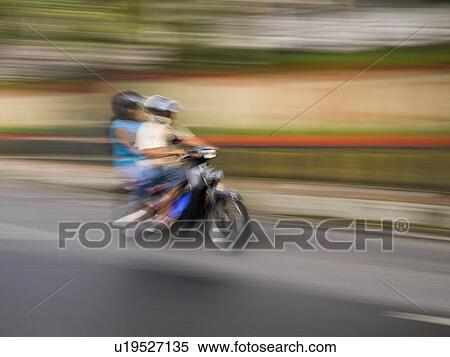Stock Photography - Motorbike on roadway in Bali. Fotosearch