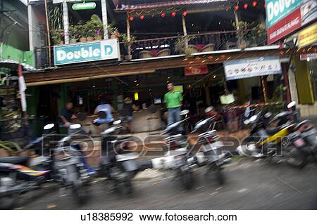 Motorbikes parked on street in Bali View Large Photo Image Stock Image - Motorbikes parked on street in Bali. Fotosearch