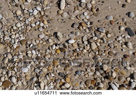 Stock Image - Pebbles on the Hampton shoreline. Fotosearch