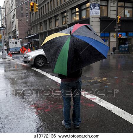 Pedestrians in the rain on the streets of Manhattan, New York City, U. S. A. View Large Photo Image Stock Photograph - Pedestrians in the rain on the streets of Manhattan, New York City, U. S. A.. Fotosearch