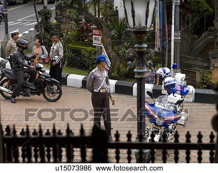 Stock Photograph - People and motorbikes in Bali. Fotosearch