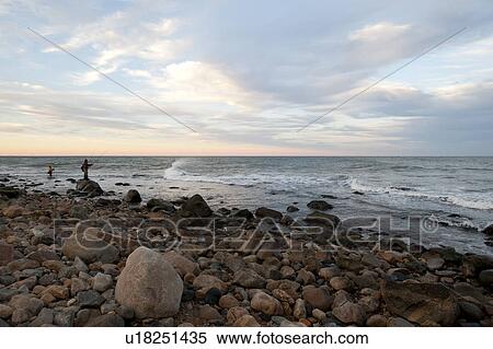 Stock Photography - People fishing off the Hampton shoreline. Fotosearch