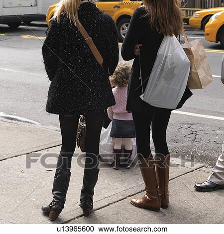 Stock Image - People on the street of Manhattan, New York City, U. S. A.. Fotosearch