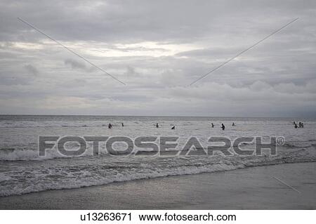 People swimming by the shoreline in Bali View Large Photo Image Stock Image - People swimming by the shoreline in Bali. Fotosearch
