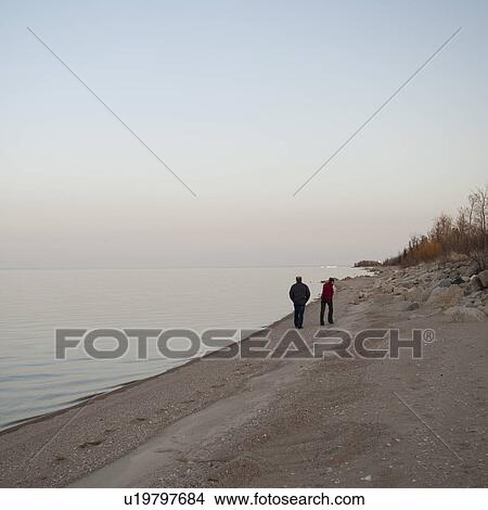 People walking along the Shoreline of Lake Winnipeg in Gimli, Manitoba, Canada View Large Photo Image Picture - People walking along the Shoreline of Lake Winnipeg in Gimli, Manitoba, Canada. Fotosearch