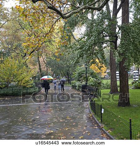 Stock Image - People walking in Madison Square Park, Manhattan, New York City, U. S. A.. Fotosearch