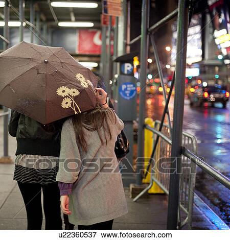 People Walking With Umbrellas On The Streets Of Manhattan New