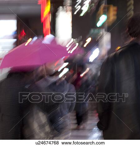 Stock Photo - People walking with umbrellas on the streets of Manhattan, New York City, U. S. A.. Fotosearch