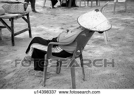 Stock Photo - Person relaxing in a chair in Bali. Fotosearch