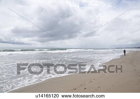 Person walking along beach in Bali View Large Photo Image Stock Image - Person walking along beach in Bali. Fotosearch