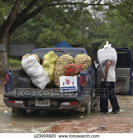 Stock Image - San Ignacio, Transporting Food. Fotosearch