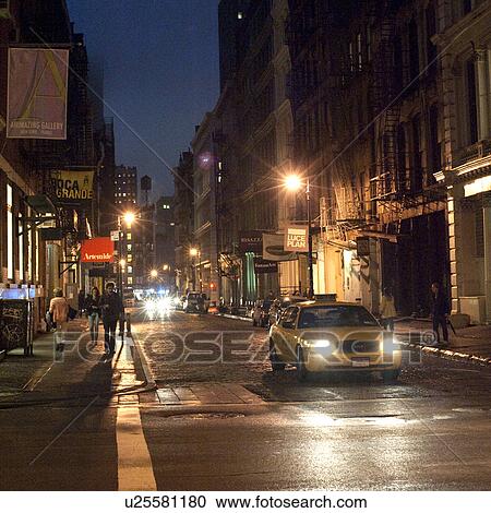 Stock Image - Street at night in Manhattan, New York City, U. S. A.. Fotosearch