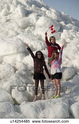 Three girls standing on an ice wall in Gimli, Manitoba, Canada View Large Photo Image Stock Photography - Three girls standing on an ice wall in Gimli, Manitoba, Canada. Fotosearch