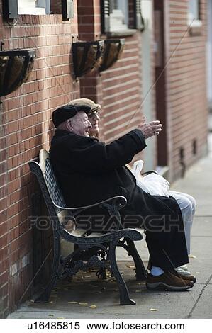 Stock Photography - Two men sitting on a bench in Boston, Massachusetts, USA. Fotosearch