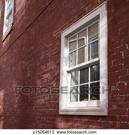 Stock Image - Windows and brick exterior of a building in the Hamptons. Fotosearch