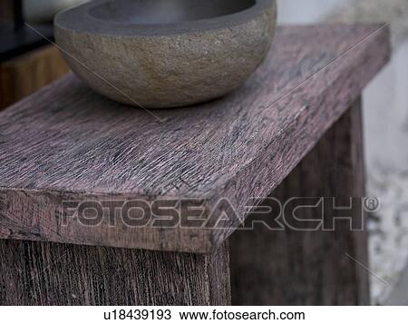 Stock Image - Wooden bowl on a stool. Fotosearch