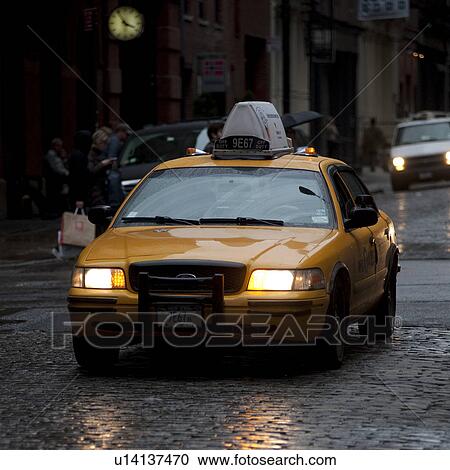 Stock Image - Yellow taxi in Manhattan, New York City, U. S. A.. Fotosearch