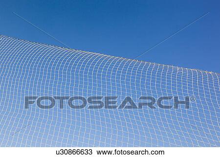 Stock Image - pattern created by string netting against a blue sky. Fotosearch