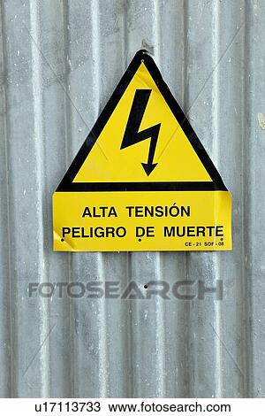 Stock Image - torremolinos, malaga, andalusia, spain; a spanish language sign "alta tension; peligro de muerte" meaning "high tension; danger of death". Fotosearch