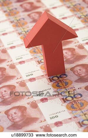 Stock Image - A arrow sign pointing up on Chinese Currency. Fotosearch