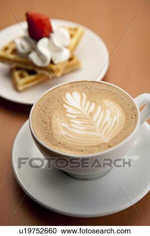 Afternoon tea, Coffee, Close-up of a cup of cappuccino with pattern and dessert on the saucer View Large Photo Image Stock Image - Afternoon tea, Coffee, Close-up of a cup of cappuccino with pattern and dessert on the saucer. Fotosearch
