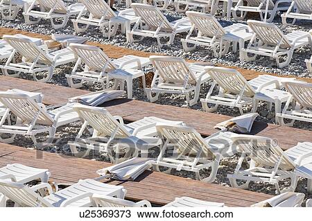 Stock Image - Beach and chairs at Nice, France. Fotosearch