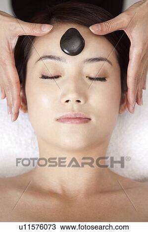 Beauty Treatment, Close-up of woman enjoying massaging with eyes closed View Large Photo Image Stock Image - Beauty Treatment, Close-up of woman enjoying massaging with eyes closed. Fotosearch